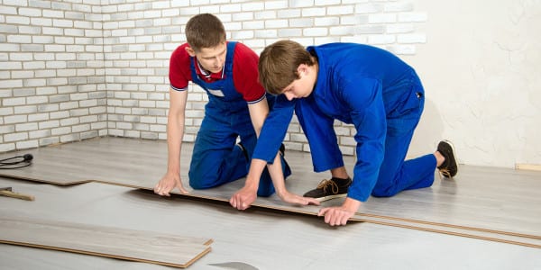 men installing laminate floor covering